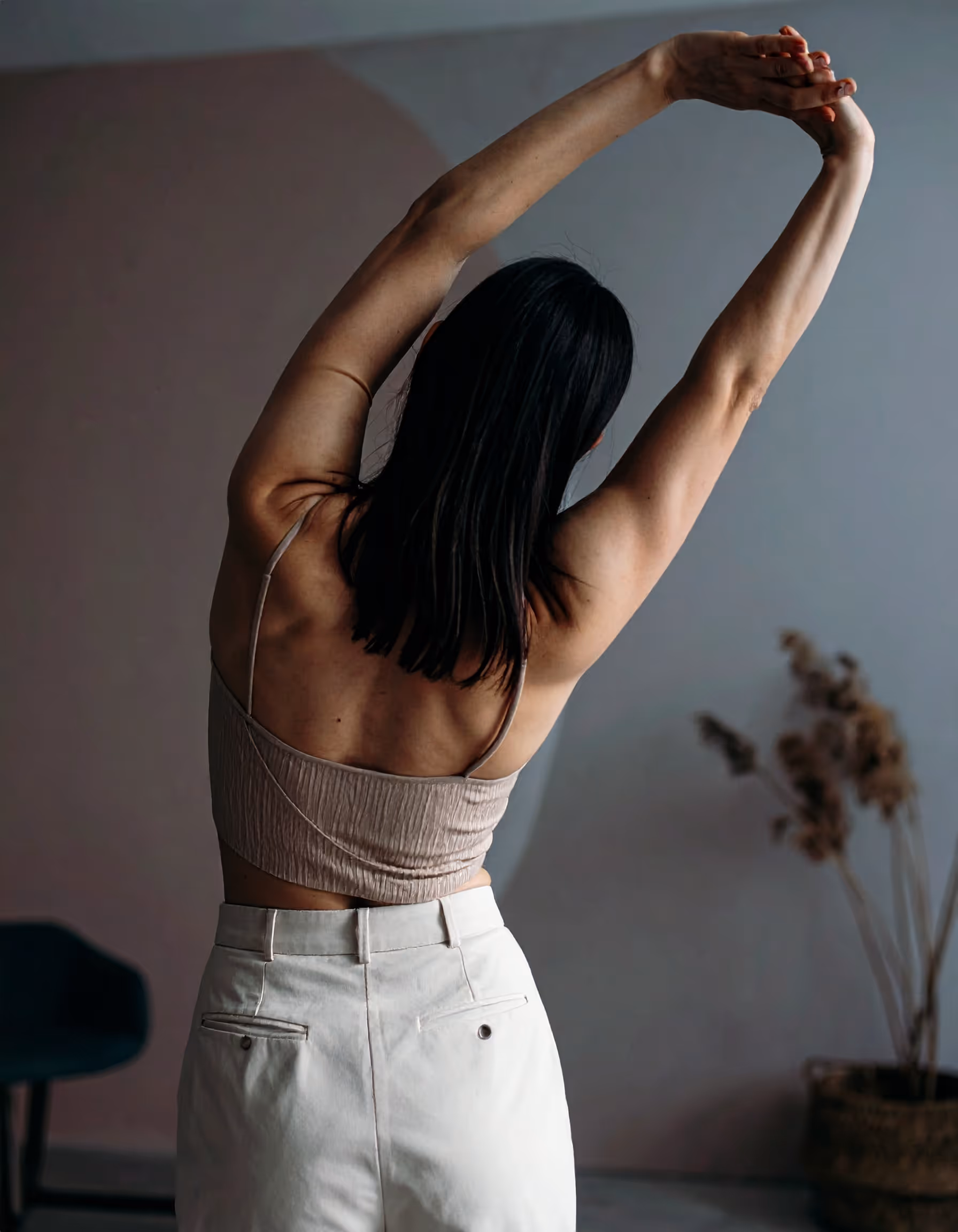 image of woman from behind softly stretching
